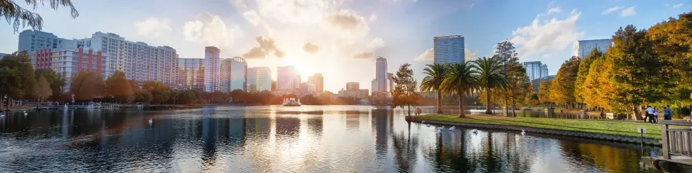 Sunset at Orlando in Lake Eola Park with water fountain and city skyline, Florida, USA